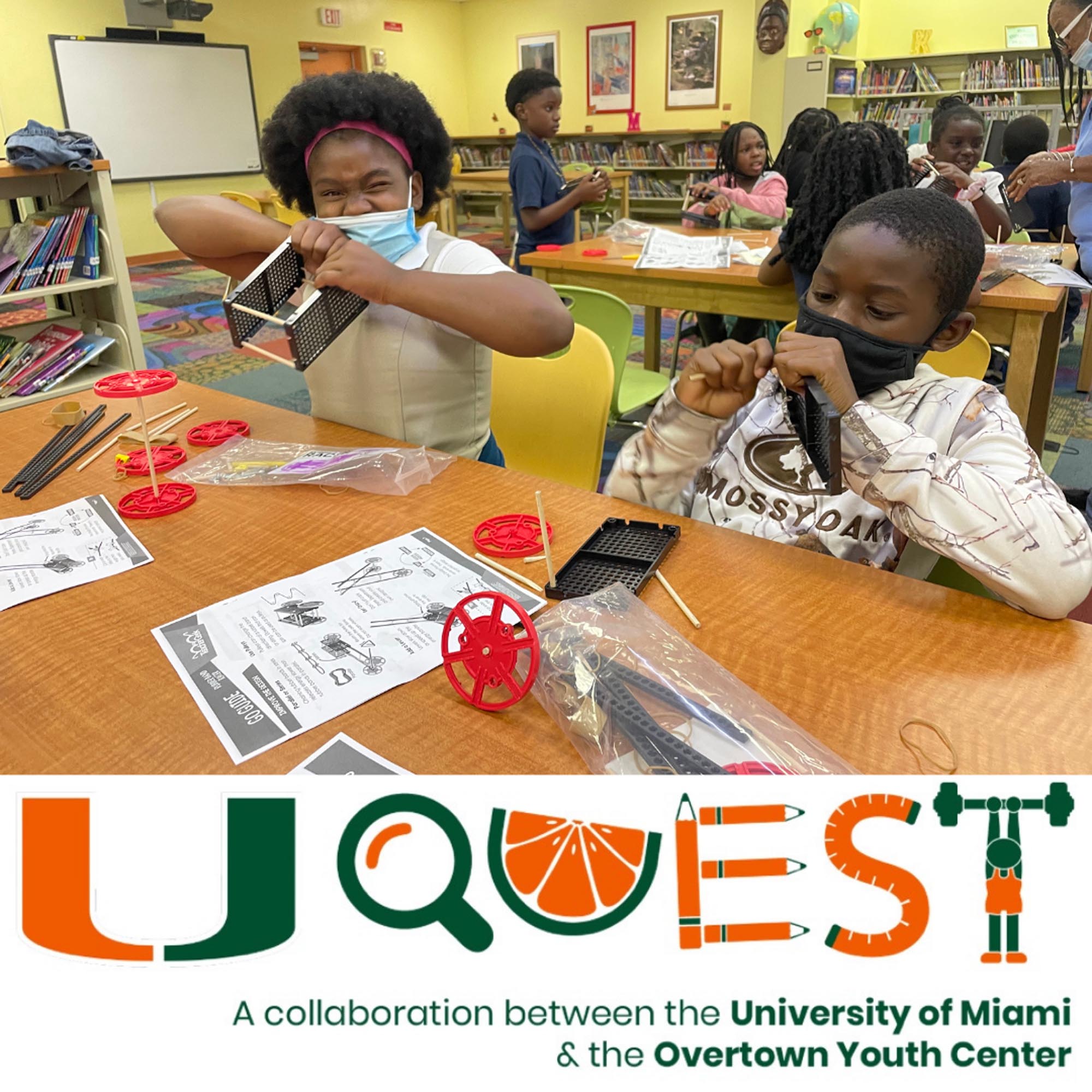 two children build a robotics project in a classroom