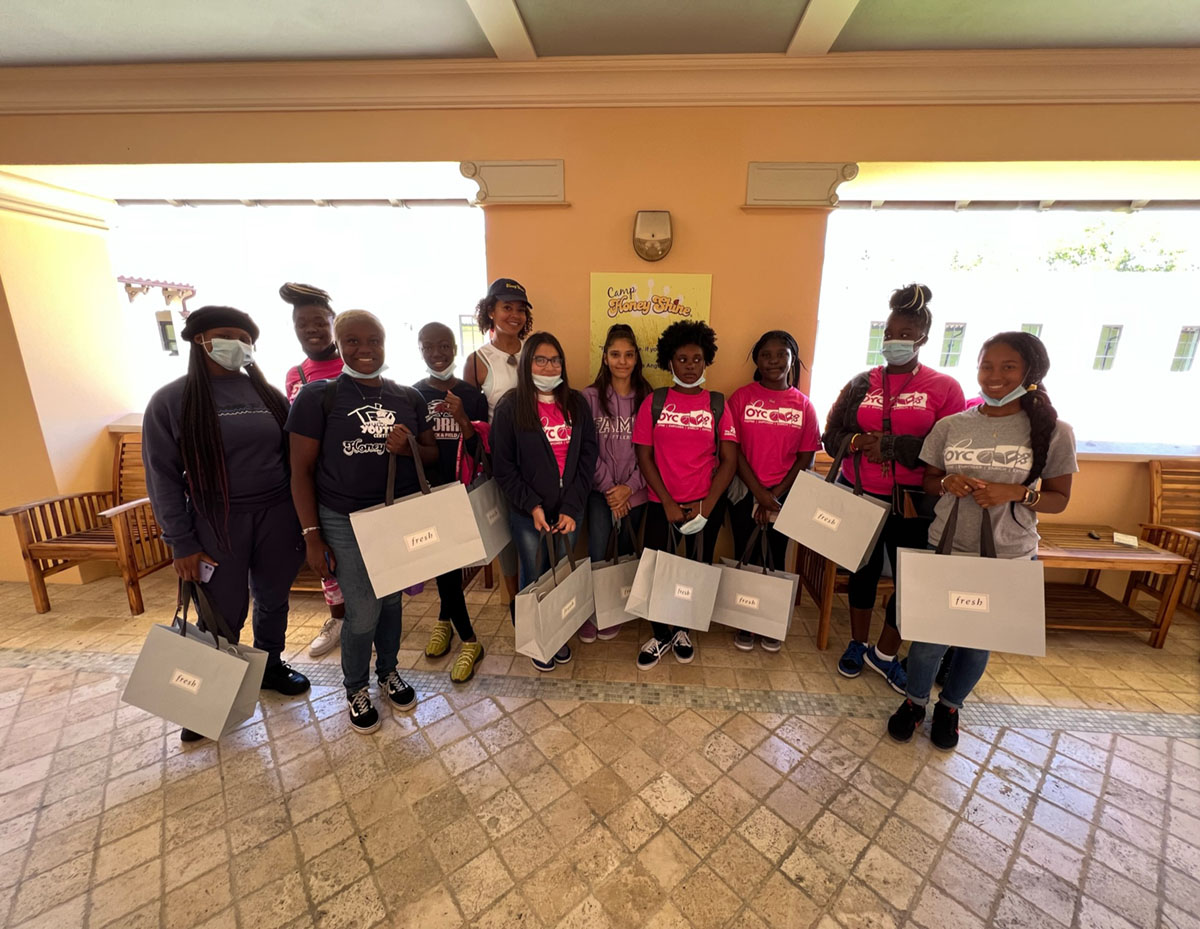 OYC students hold bags of producs from partner LVMH