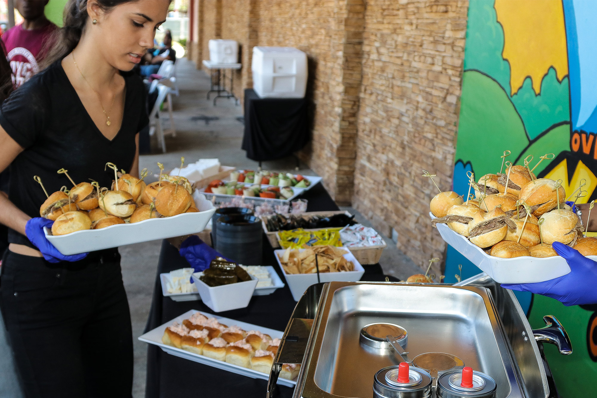 Volunteers serve food at OYC Miami