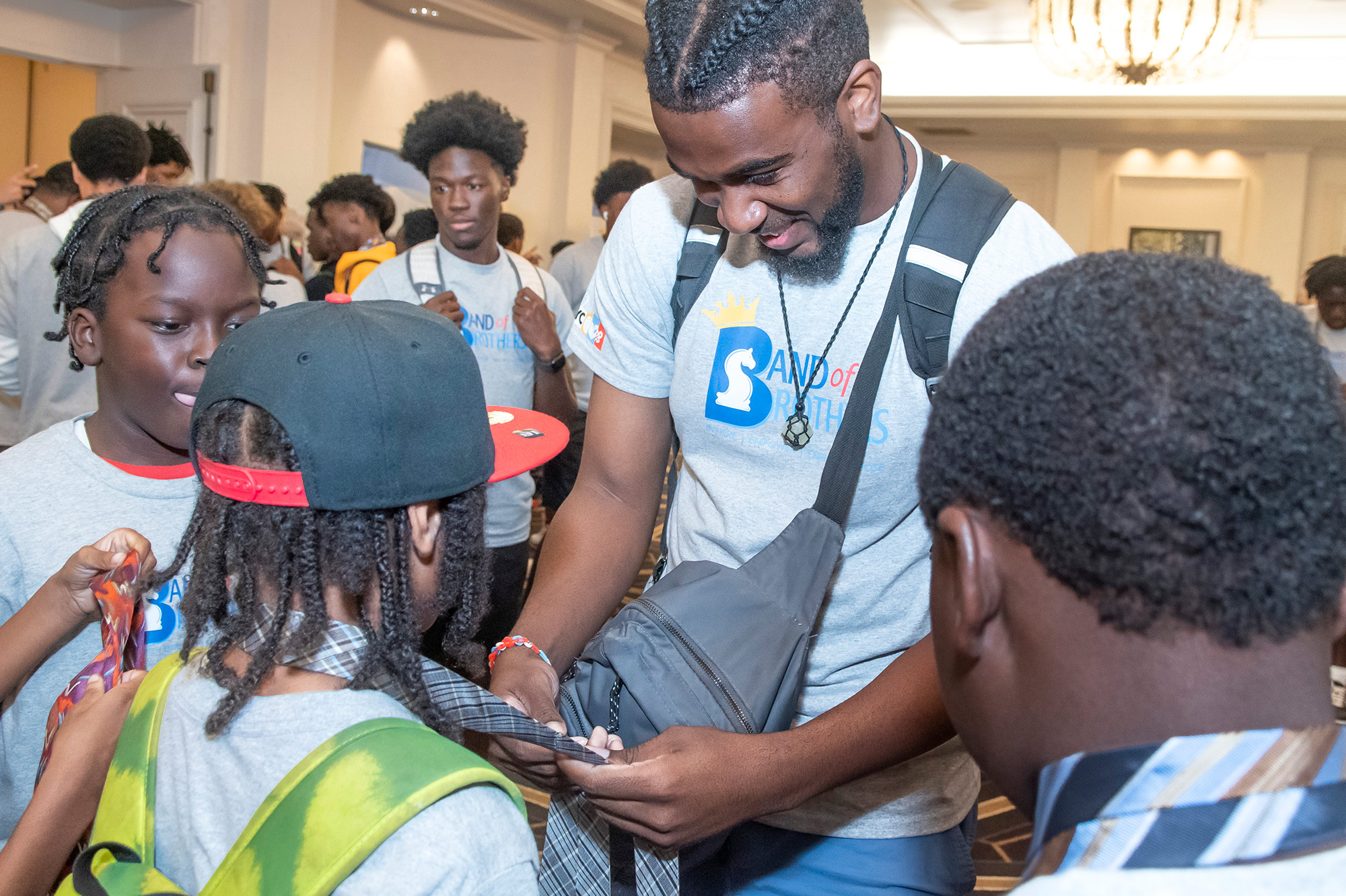 a group of young men watch a video clip on a mobile phone