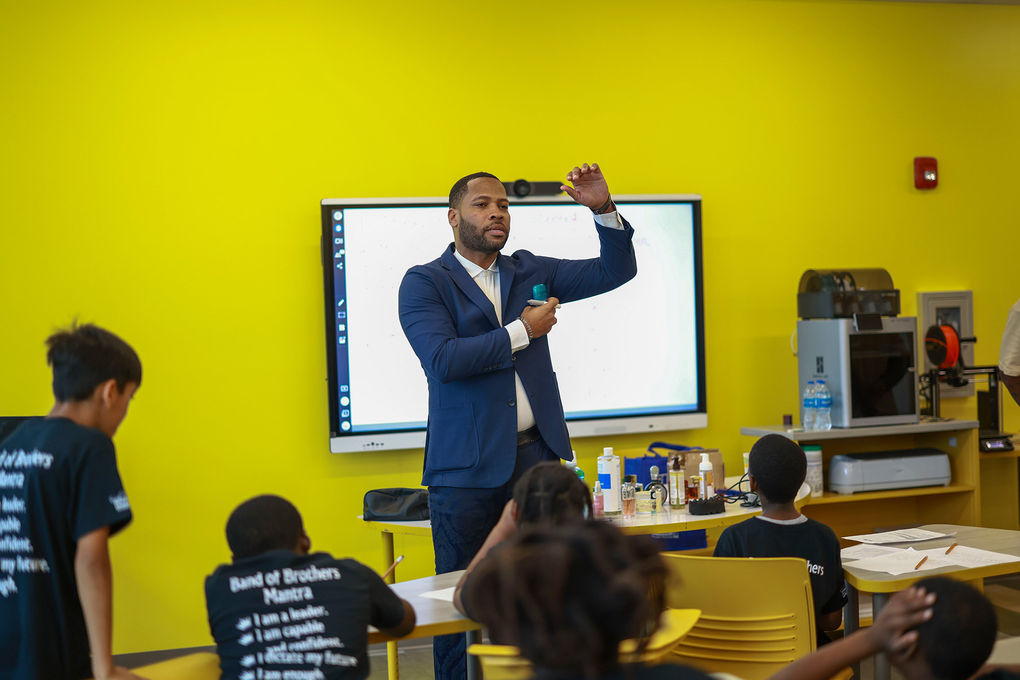 a speaker addresses a classroom of young boys