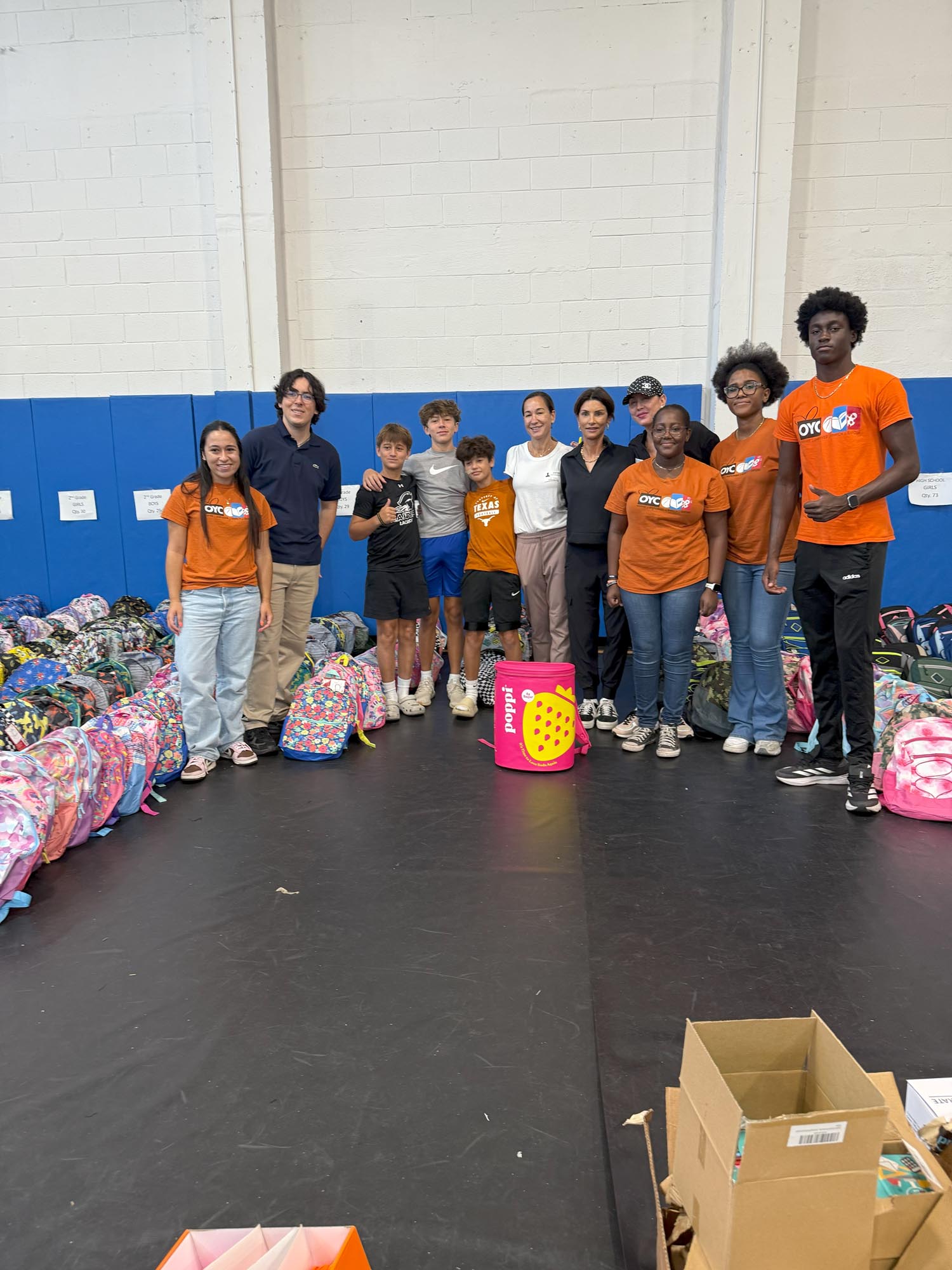 a group of children with newly donated backpacks