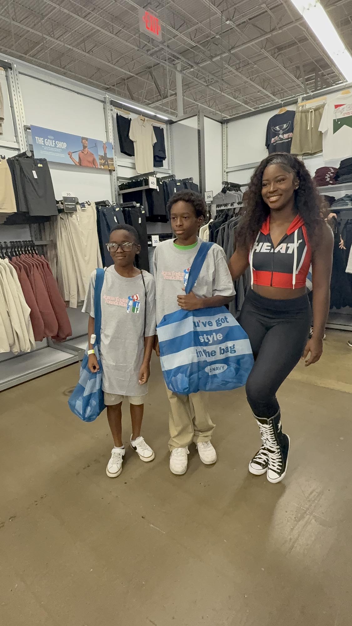 two young students and mom display new back-to-school gear