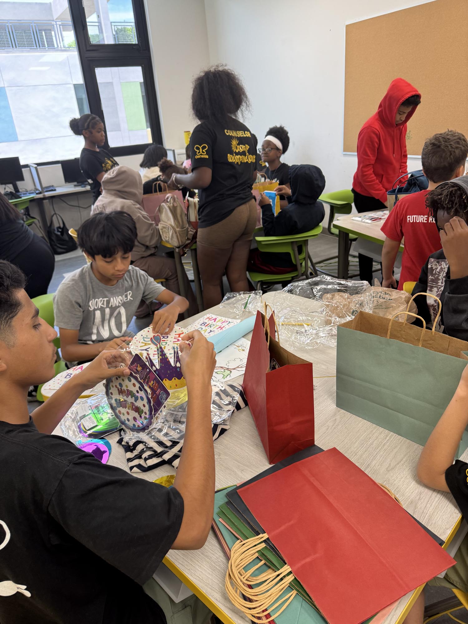 children at a table packing birthday gift bags