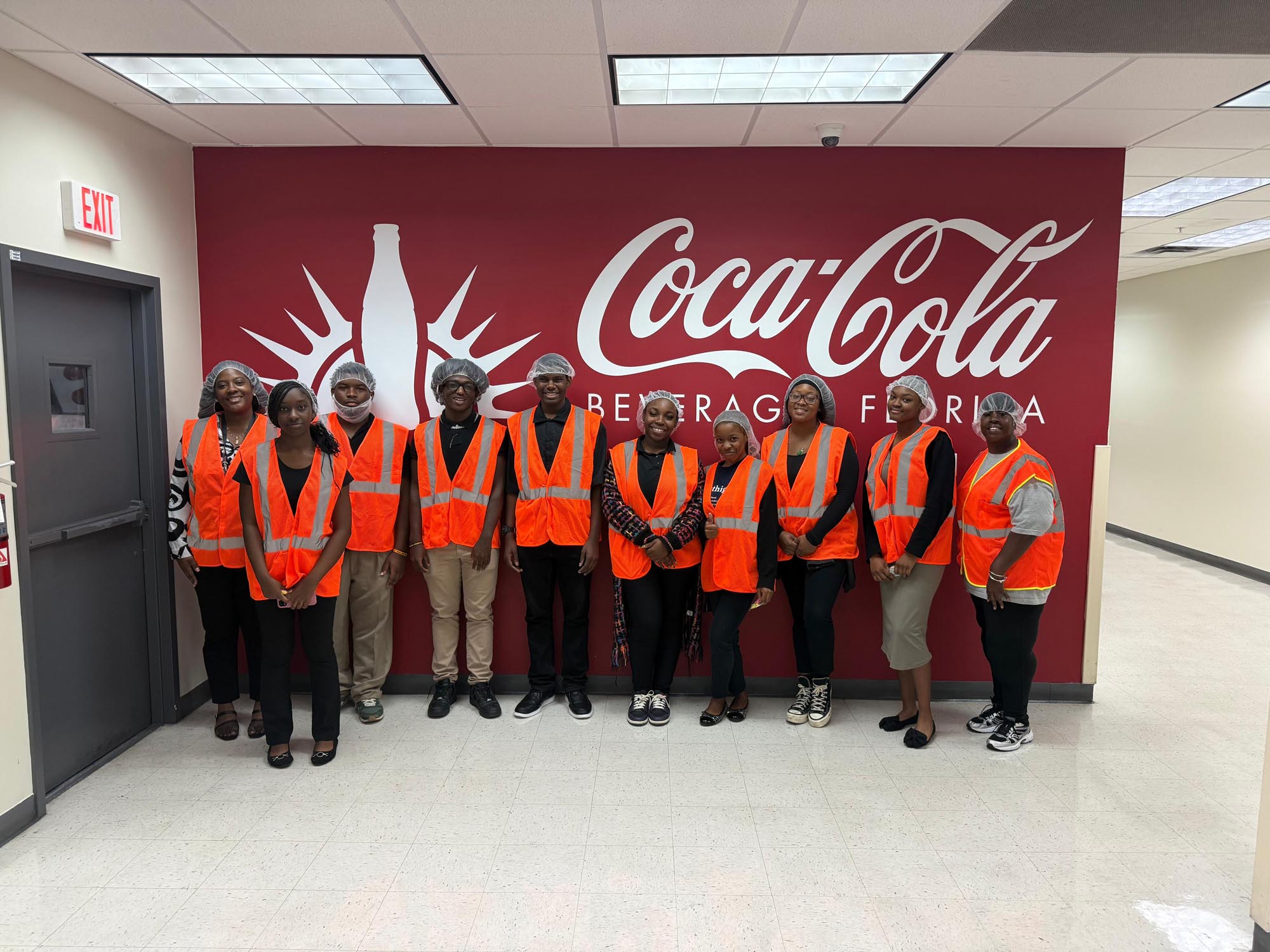 a group of OYC students wear safety gear while visiting the Coca-Cola distribution facility in Miami