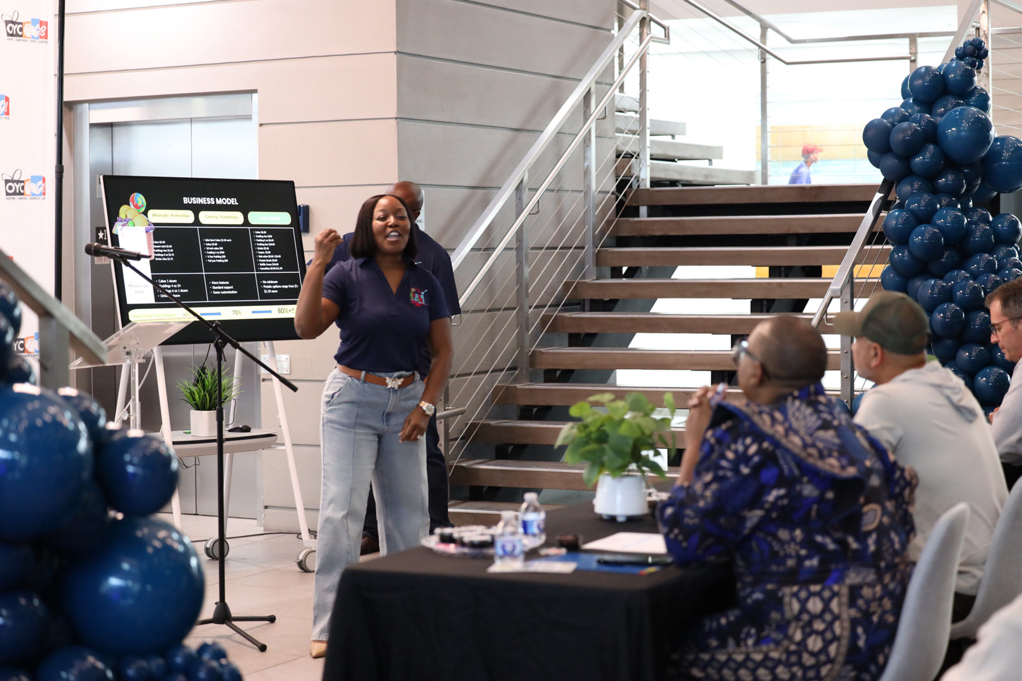 a young woman pitches her idea to a panel of judges