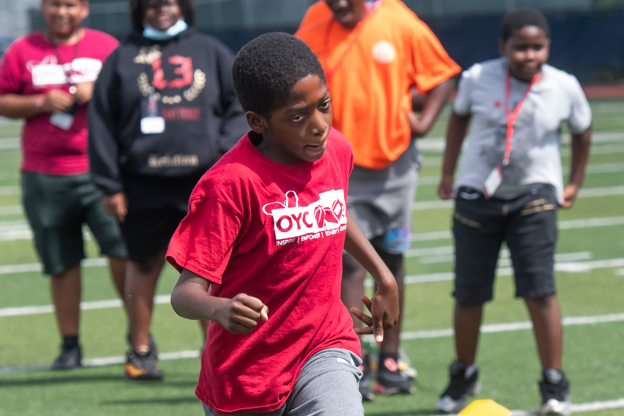 a young boy runs on a field