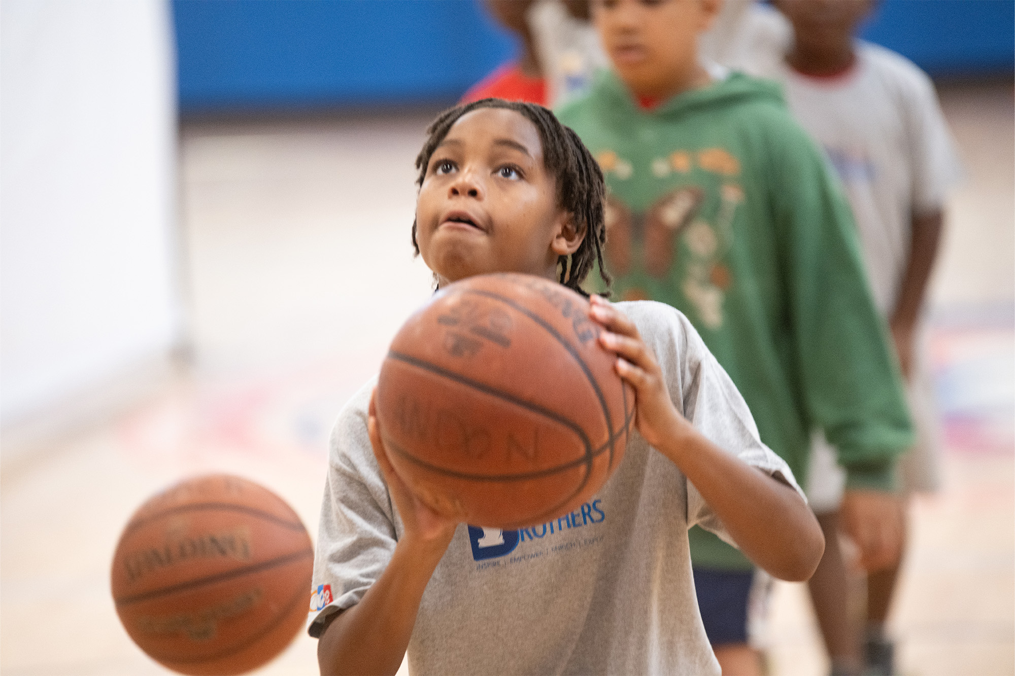 a boy prepares to shoot a basketball at the basket