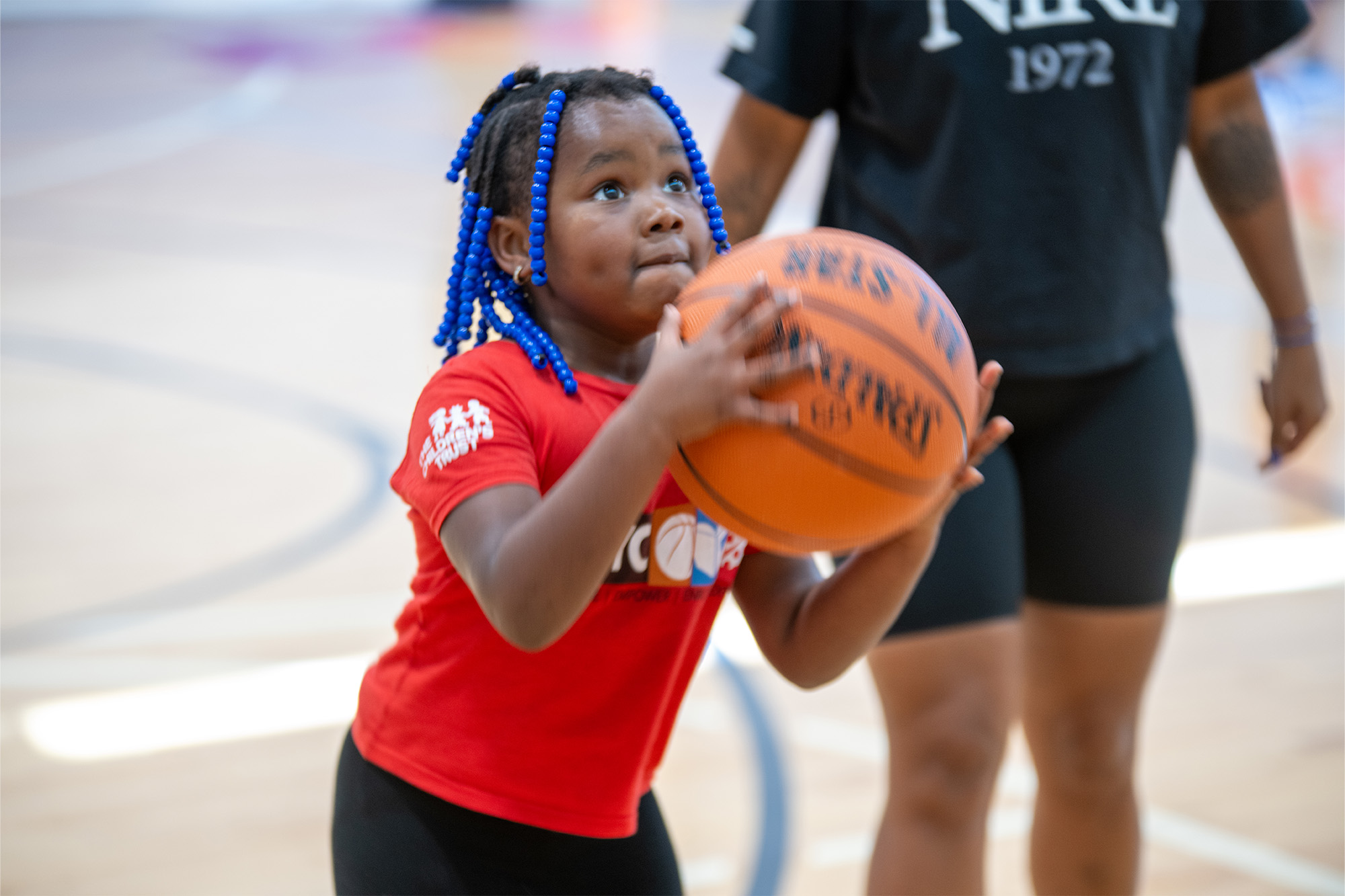 A young girl prepares to shoot a basketball