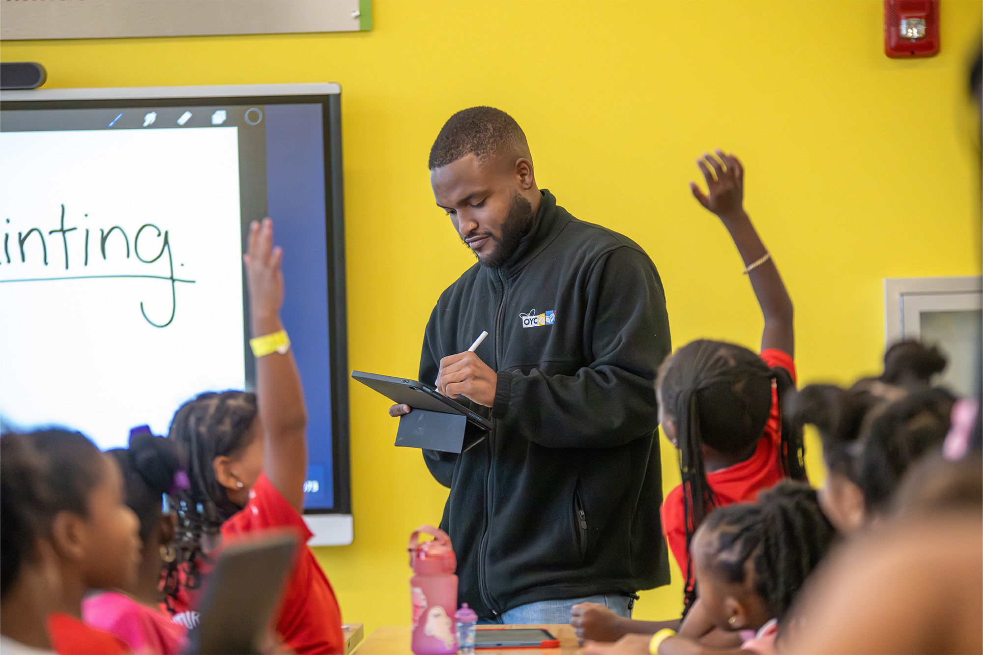 an instructor takes roll in a classroom