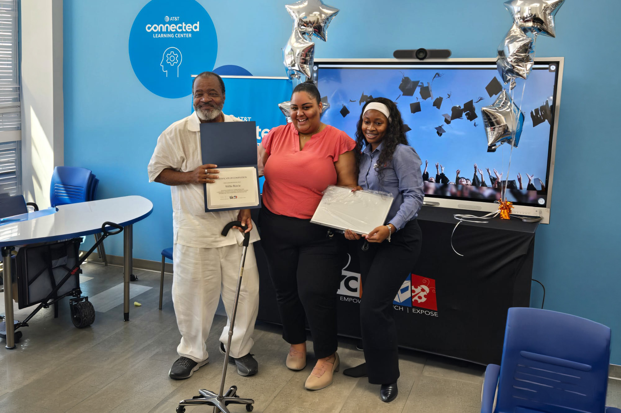 a group of adults displays their newly-earned certificates