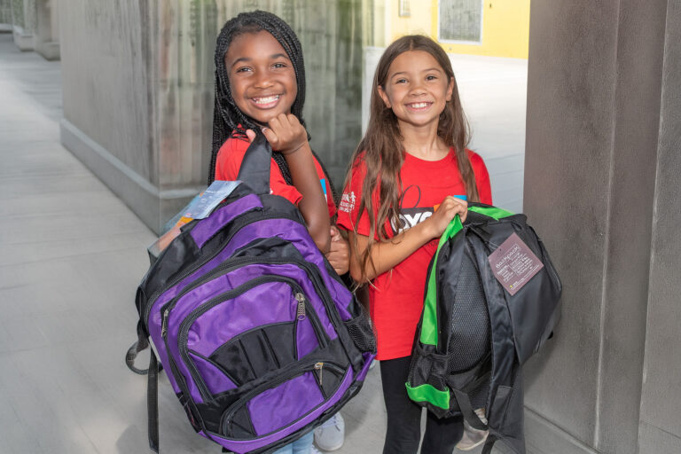 two young girls with new backpacks