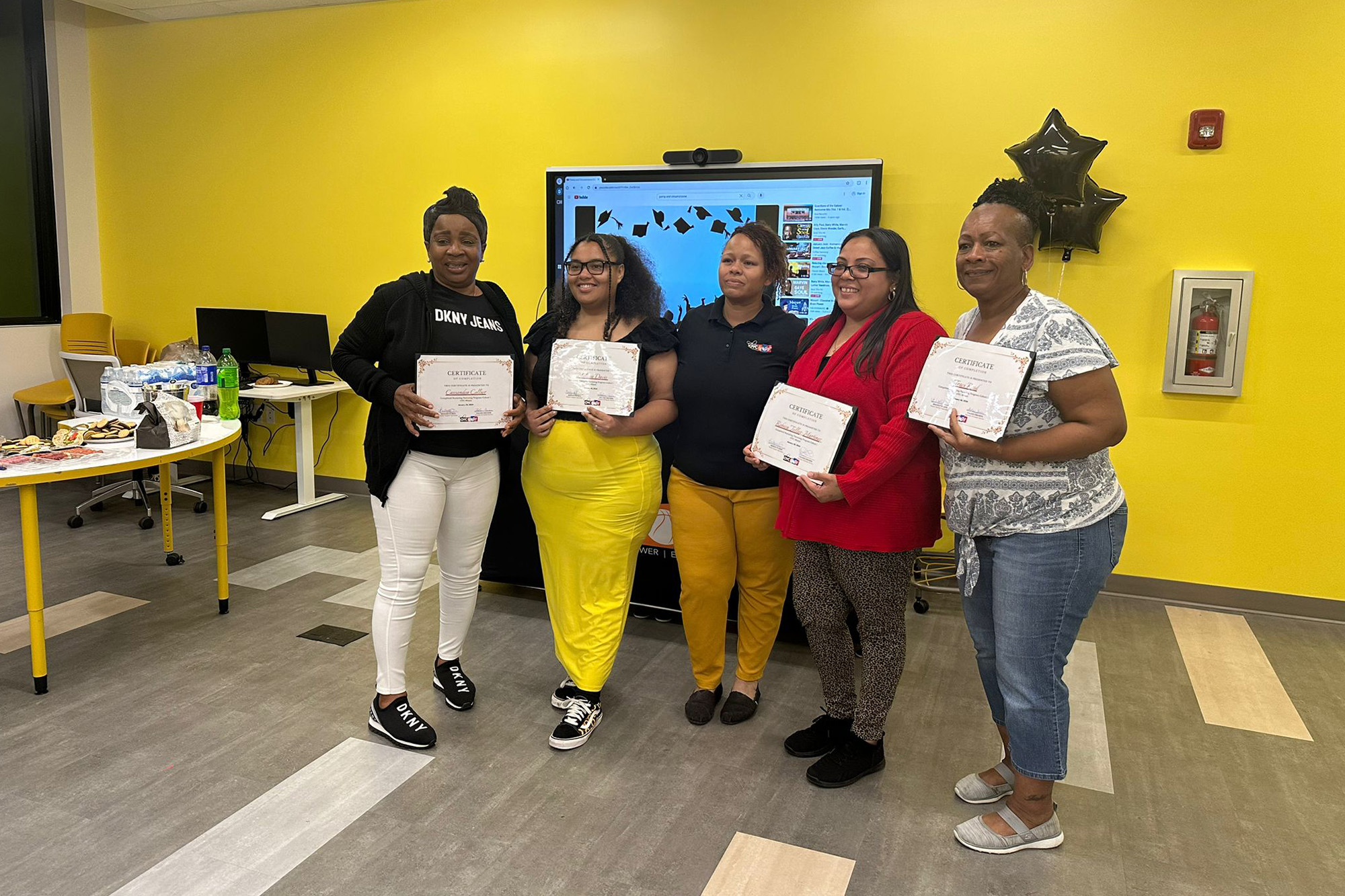 five ladies holding certificates standing side by side