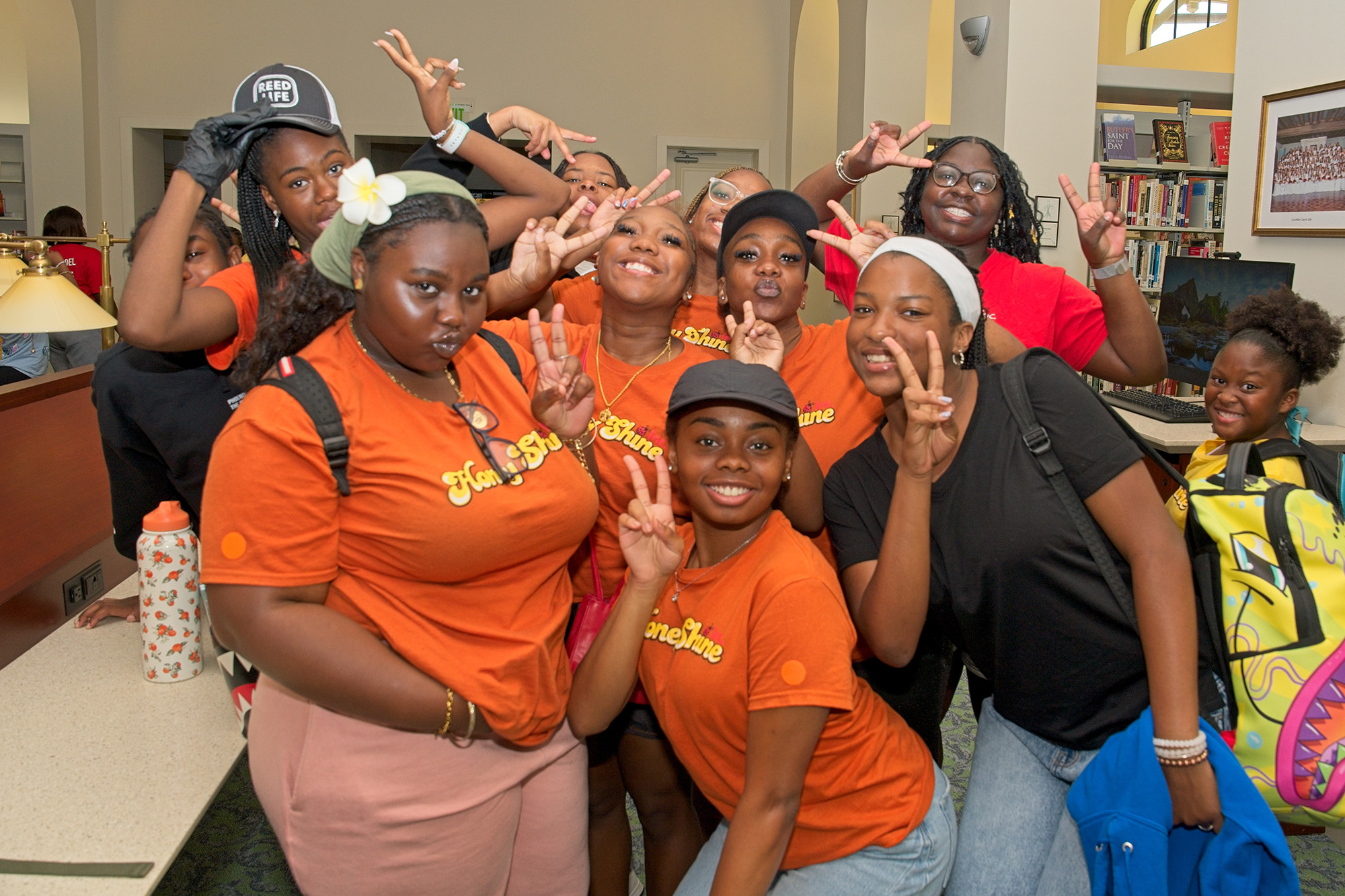 a group of girls poses for a photo in a library